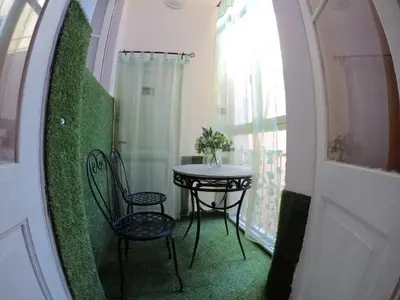 a table and chairs in a room with a window at Julius Caesar 183 in Rome