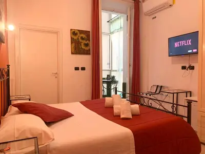 a bedroom with a bed with a television on the wall at Julius Caesar 183 in Rome