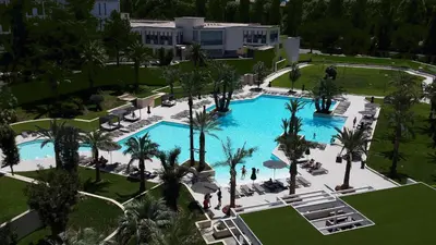 an overhead view of a resort pool with palm trees at Ergife Palace Hotel in Rome