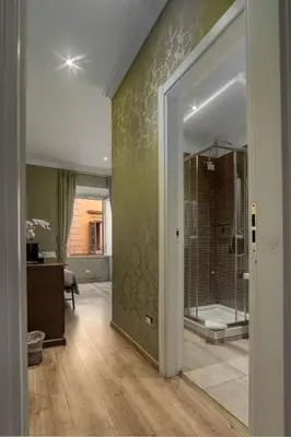 a bathroom with a walk in shower and a glass door at BQ House Trevi Luxury Rooms in Rome