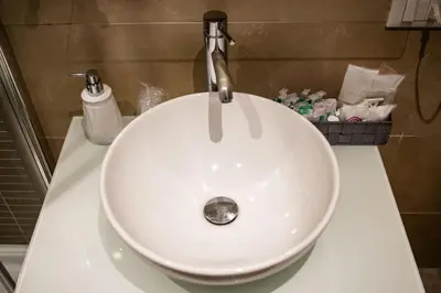 a white sink with a faucet on a counter at BQ House Trevi Luxury Rooms in Rome