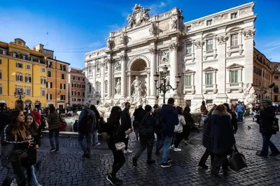 a group of people walking in front of a building at BQ House Trevi Luxury Rooms in Rome