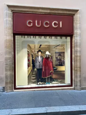 a display window of a gucci store with two mannequins at Casa Camilla in Rome