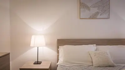 a bedroom with a bed and a lamp on a table at Rental in Rome Pelliccia in Rome