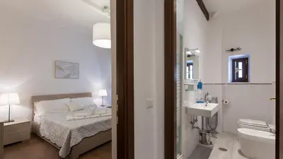 a bedroom with a bed and a bathroom with a sink at Rental in Rome Pelliccia in Rome