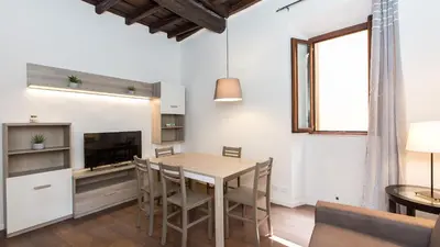 a kitchen and dining room with a table and chairs at Rental in Rome Pelliccia in Rome