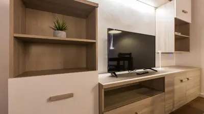 a bathroom with a vanity with a mirror and a tv at Rental in Rome Pelliccia in Rome