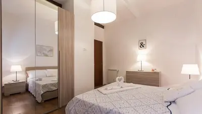 a bedroom with two beds and a mirror at Rental in Rome Pelliccia in Rome