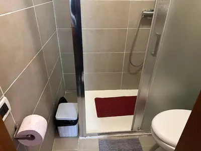 a small bathroom with a shower with a toilet at Kobe's Apartment in Rome