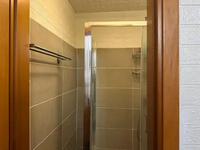 a shower with a glass door in a bathroom at Kobe's Apartment in Rome