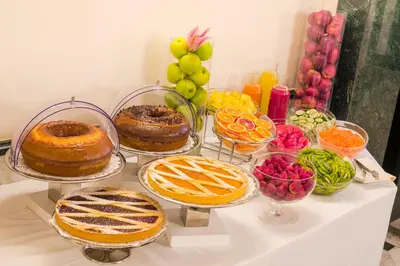 a table topped with pies and other food items at Raeli Hotel Regio in Rome