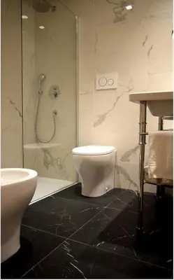 a bathroom with a shower and a toilet and a sink at Raeli Hotel Archimede in Rome
