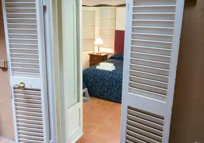 a door leading to a bedroom with a bed at Farnese 48 in Rome