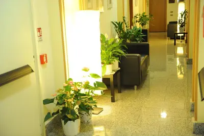 a hallway with potted plants in a lobby at Lux Appartamenti in Rome