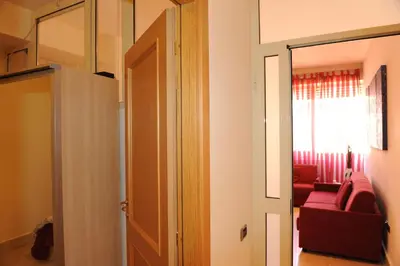 a door leading to a living room with a red couch at Lux Appartamenti in Rome