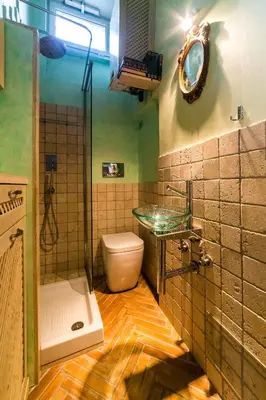 a bathroom with a toilet and a glass sink at maison specchi in Rome