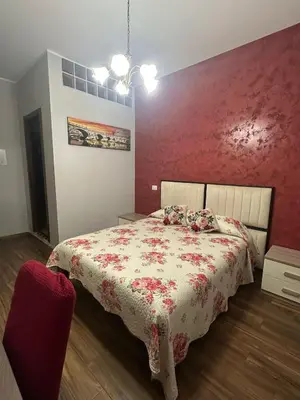 a bedroom with a bed with a red wall at Royal Termini in Rome