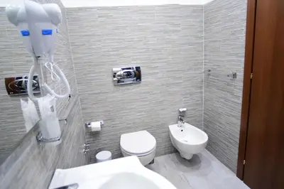 a bathroom with a white toilet and a sink at Royal Termini in Rome