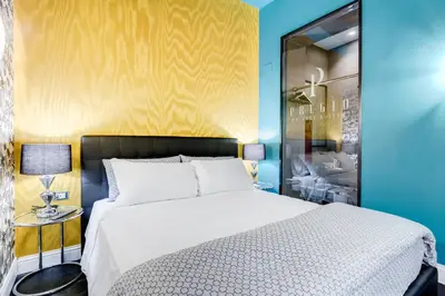 a bedroom with a bed and a blue wall at The French suites by oneup Hospitality in Rome