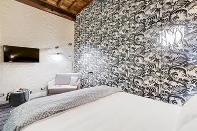 a bedroom with a bed and a wall mural at The French suites by oneup Hospitality in Rome
