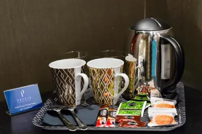 a tray with two coffee mugs and a coffee maker at The French suites by oneup Hospitality in Rome