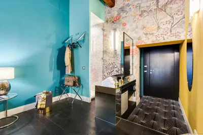a bathroom with blue walls and a sink and a mirror at The French suites by oneup Hospitality in Rome