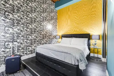 a bedroom with a bed and a wall mural at The French suites by oneup Hospitality in Rome