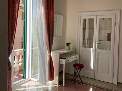 a room with a desk and a sliding glass door at Domus Claudia San Giovanni in Rome