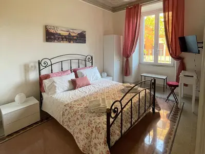 a bedroom with a bed and a window at Domus Claudia San Giovanni in Rome