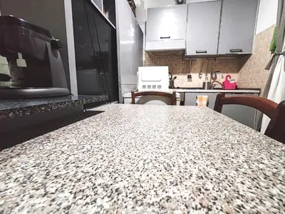 a kitchen with a table with a counter top at In the Heart of Rome in Rome