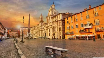 a bench in the middle of a city street at In the Heart of Rome in Rome