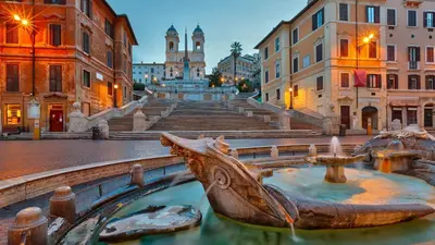 a statue of a boat in the middle of a street at In the Heart of Rome in Rome