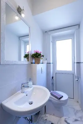 a white bathroom with a sink and a toilet at Marco Polo Vatican APARTMENT Metro A 2 min - San Pietro 10 min in Rome