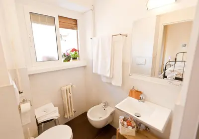 a white bathroom with a sink and a toilet at Marco Polo Vatican APARTMENT Metro A 2 min - San Pietro 10 min in Rome