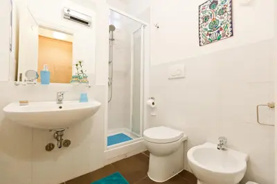 a white bathroom with a sink and a toilet at Marco Polo Vatican APARTMENT Metro A 2 min - San Pietro 10 min in Rome