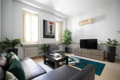 a living room with a couch and a tv at Dimora storica Palazzo Marescalchi Belli in Rome