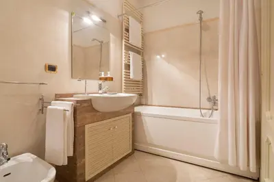a bathroom with a sink and a tub and a toilet at Dimora storica Palazzo Marescalchi Belli in Rome