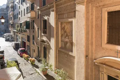 a painting on the side of a building on a street at Dimora storica Palazzo Marescalchi Belli in Rome
