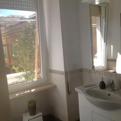 a bathroom with a sink and a window at flaminio heart house in Rome