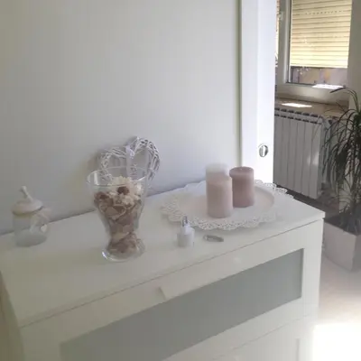 a white table with a vase and candles on it at flaminio heart house in Rome