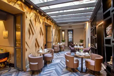 a restaurant with a row of tables and chairs at The Style in Rome