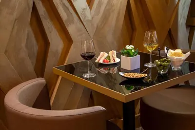a table with wine glasses and a plate of food at The Style in Rome