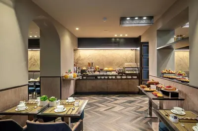 a restaurant with two tables and a kitchen in the background at The Style in Rome
