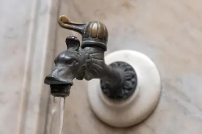 a metal faucet with water coming out of it at Hotel S. Anna in Rome