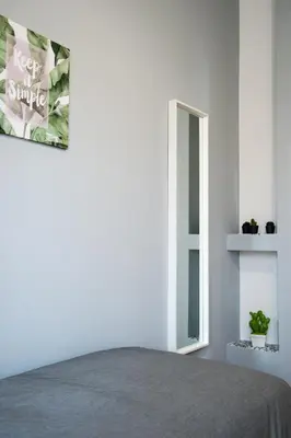 a bedroom with a bed and a mirror at Enjoy Porta Furba in Rome
