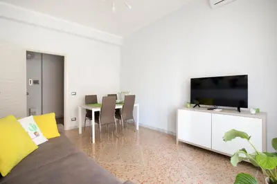 a living room with a couch and a table with chairs at Enjoy Porta Furba in Rome