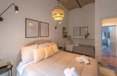 a bedroom with a large bed and a couch at colosseo flats and penthouse in Rome