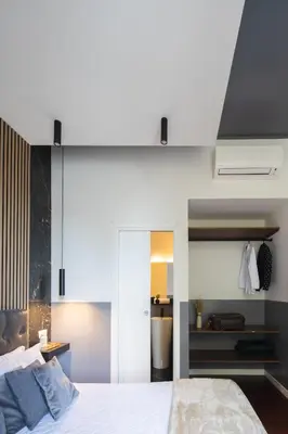 a bedroom with a large white bed and a room at colosseo flats and penthouse in Rome