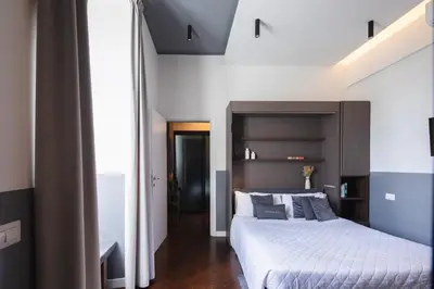 a bedroom with a large bed in a room at colosseo flats and penthouse in Rome