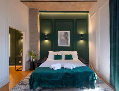 a bedroom with a large bed with two towels on it at colosseo flats and penthouse in Rome